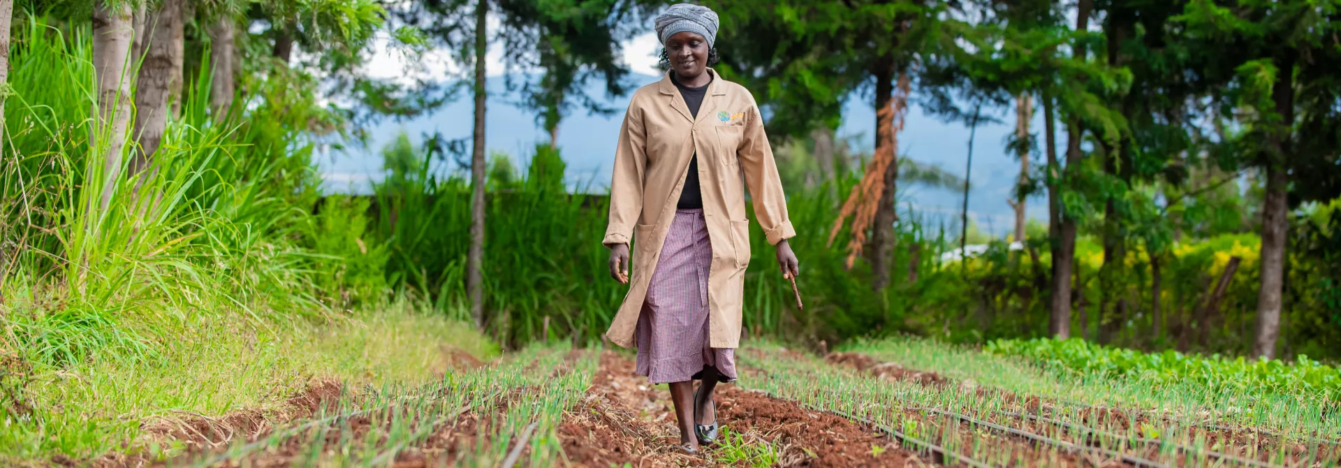 Mercy Gatwiri walks through irrigated crop beds in Kenya, working at the nexus of regenerative agriculture and renewable energy.