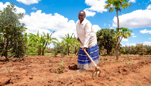 Amina Njeru preparing her land for planting in Kenya