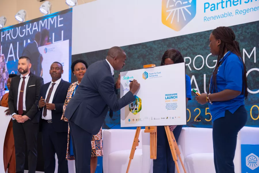 Eng. Dominic Banaga, representing the Ministry of Water and Environment, signs the Power for Food Partnership commitment board at the Uganda Programme Launch, Kampala, 2 December 2025. Photo: SNV